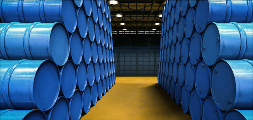 Stacked blue chemical barrels in warehouse