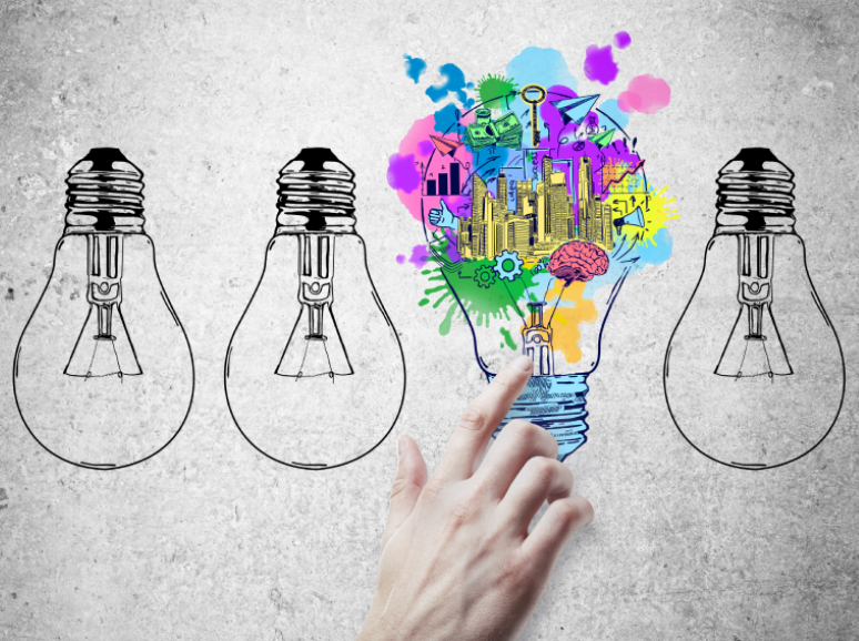 Hand pointing at colorful creative light bulb