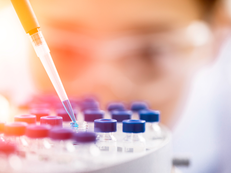 Lab technician using pipette in a laboratory